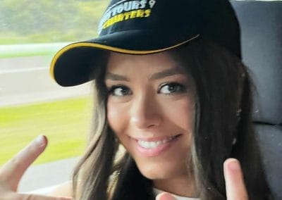 Woman in cap, peace signs.